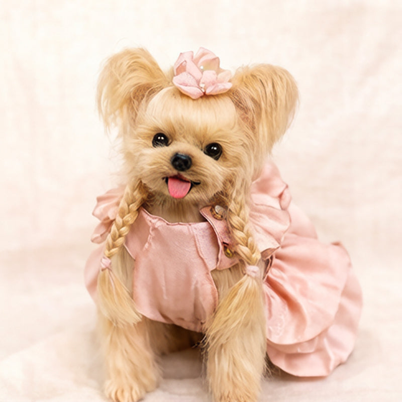 Handmade wool dog doll, front view, wearing a pink dress, with braided hair and flower accessory, cute collectible