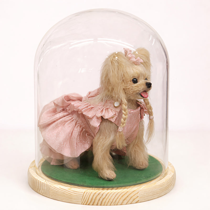 Handmade wool dog doll, side view under glass dome, cute decorative plush, pink dress and braided flower hair